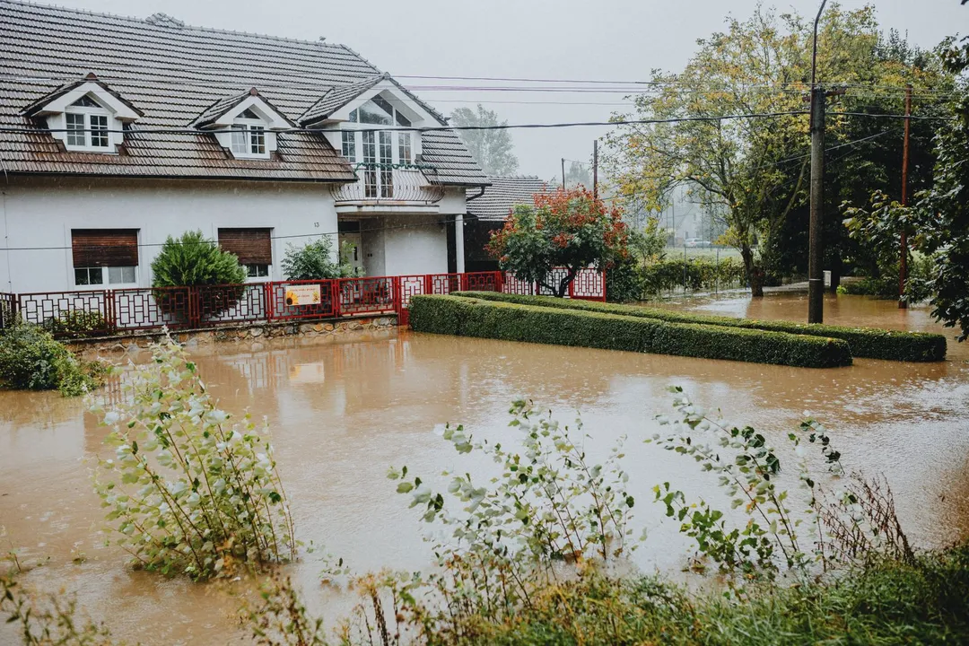 Floodwater surrounding a home during heavy rain
